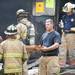 A firefighter distributed pizza at the scene of an explosion at a house on Gattegno Street in Ypsilanti Township on Sunday, July 7. Daniel Brenner I AnnArbor.com